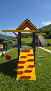 a playground with a colorful play structure on the grass at Etno Selo Relax in Šipovo