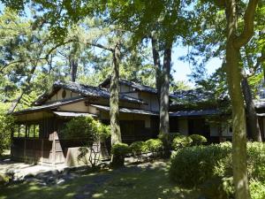 a house with trees in front of it at Numazu Club in Numazu