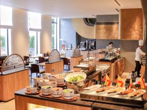 a restaurant with a buffet line with food at Hotel Trusty Tokyo Bayside in Tokyo