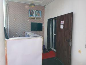 an office room with a door and a television at Lazeto Hotel and Resorts in Zongon Daji