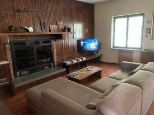 a living room with a couch and a fireplace at VILLA SECCHI in Castelcovati