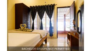 a bedroom with a bed and a large window at Jonirene Seasands Homestay in Alleppey