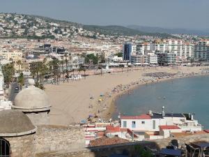 a view of a beach with people on it at Portal Fosc Suites in Peniscola