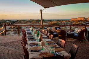 a long table on a deck with a view of the desert at Sal Salis Ningaloo Reef in Exmouth