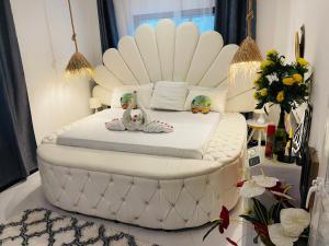 a white bed in a room with two stuffed animals on it at Malaika white house in Kiwengwa
