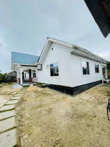 a white house with a yard at Malaika white house in Kiwengwa