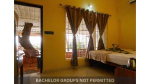 a bedroom with a bed and a window at Jonirene Seasands Homestay in Alleppey +47 photos