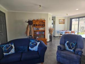a living room with two blue chairs and a table at Wudinna Farm View in Wudinna