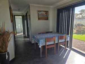 a dining room with a table and chairs and a window at Wudinna Farm View in Wudinna +13 photos