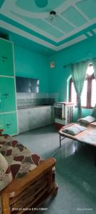 a bedroom with two beds and a green wall at Rawat Homestay in Rishīkesh