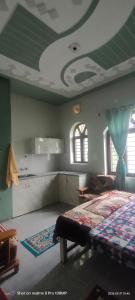 a bedroom with a bed and a green ceiling at Rawat Homestay in Rishīkesh
