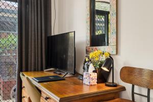 a desk with a flat screen tv on top of it at Group stays for Friends Families Weddings and Events Walkable to Fremantle and attractions Super Spacious with garden and courtyard and balcony and parking for 2 cars Sleeps 6 3BD 3BR in Fremantle