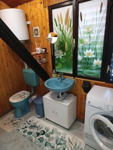 a bathroom with a sink and a washing machine at Apartman "SaraP" Metković in Metković +61 photos
