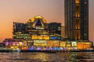 a lit up building in front of a city at night at Longzhu Guesthouse in Bangkok