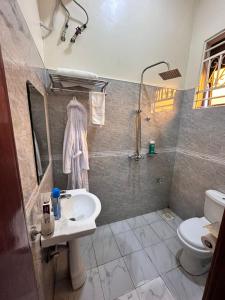 a bathroom with a sink and a toilet at GRACE ViLLA in Kitende