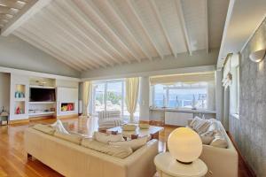 a living room with a couch and a table at Villa Helios Corfu Kassiopi in Kassiopi