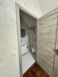 an open door to a bathroom with a toilet at Sultan Saray in Osh +50 photos