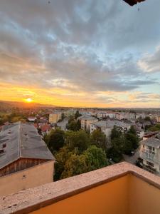 a view of a city at sunset from a balcony at Modern Panoramic View Apartament in Sighetu Marmaţiei