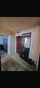 a kitchen with a refrigerator and a tv in it at Modern Panoramic View Apartament in Sighetu Marmaţiei
