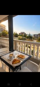 a table with two plates of food on a balcony at Villa Kreshta in Ksamil