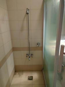 a shower with a glass door in a bathroom at The Exclusive House in Peshawar +25 photos
