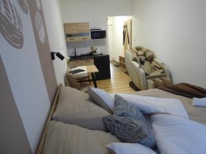 a room with two beds and a living room at Pogácsás Apartman III in Tokaj