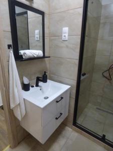 a bathroom with a white sink and a shower at Pogácsás Apartman III in Tokaj +21 photos