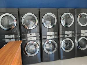 a row of washers and dryers in a laundrette at SabinaGateway Suites in Panglao Island