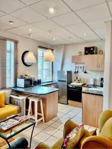 a large kitchen with a large island in a room at The Skinny Expat - Paarl - Self Catering Apartment in Paarl
