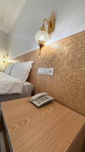 a room with a desk with a phone on it at The Garden of Shaherezade in Bukhara +26 photos