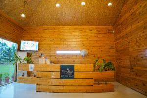 a restaurant with a wooden wall with a bench at White Petals Resort in Bangalore +69 photos
