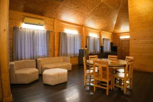 a room with a table and chairs and a dining room at White Petals Resort in Bangalore