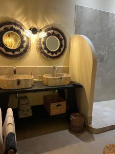 a bathroom with two sinks and a mirror at La Belle du Sud in Saint-Joseph +38 photos