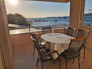 a balcony with a table and chairs and a view of the water at Villa Fontana 2 in Sukošan