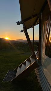 a view of the sunset from the outside of a house at Hutsul Glamp Панорамний вид Джакузі Best Sunset in Mykulychyn +14 photos