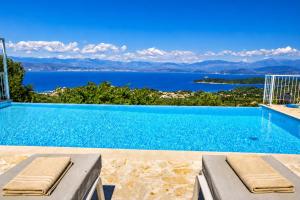 a swimming pool with a view of the water at Villa Helios Corfu Kassiopi in Kassiopi