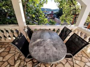 a table and chairs on a patio with a view at Mali raj in Stara Novalja