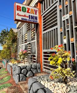 a building with a sign for a roeway inn at Rozay Travellers Inn in Kabankalan