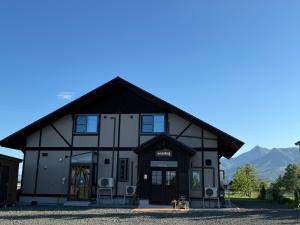 a black and white building with two dogs in front at Furano Cozy Whole House for 6 - Near lavender farm and Ski Resort - free parking in Nakafurano