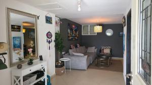 a living room with a couch and a table at BOND Grand Suites in Beer Sheva