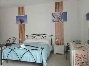 a bedroom with a bed with a blue bedspread at Sosta al 101 - Alloggio turistico in Grammichele