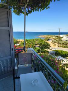 a balcony with a table and a view of the ocean at Aktio Studios in Gavrio