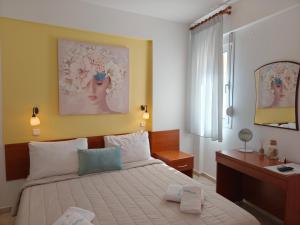 a bedroom with a bed and a desk in it at Filomeni Studios in Pefkochori
