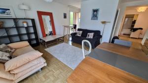 a living room with a couch and a table at Sunny Place Geneva 15 min Train in Versoix