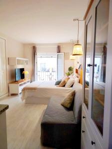 a bedroom with a large bed and a large window at LolaSuite Confort in El Rocío