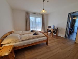 a bedroom with a bed and a table in it at Ferienwohnung Andritsch in Sankt Georgen im Gailtal
