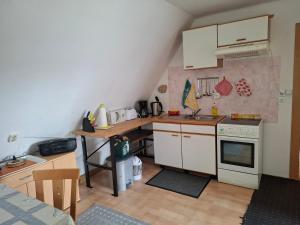 a small kitchen with a sink and a stove at Ferienwohnung Heidi in Selb