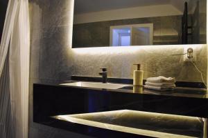 a bathroom with a sink and a mirror at Casa ZUGO in Borsec