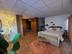 a large bedroom with a bed and a couch at Acacia Homes in Kuldanna