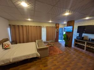 a bedroom with a bed and a flat screen tv at Acacia Homes in Kuldanna +17 photos